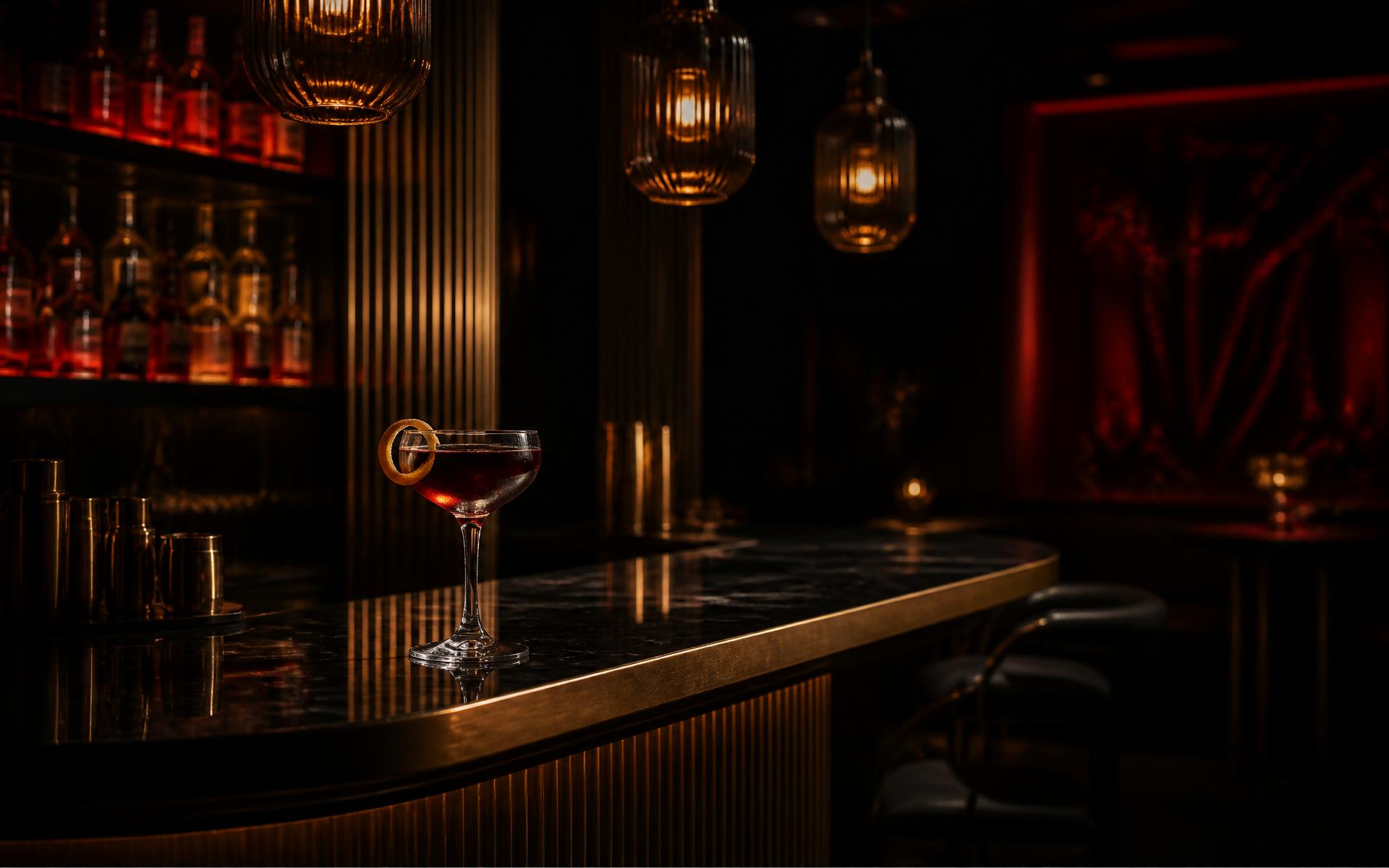 The marble and brass cocktail bar at night
